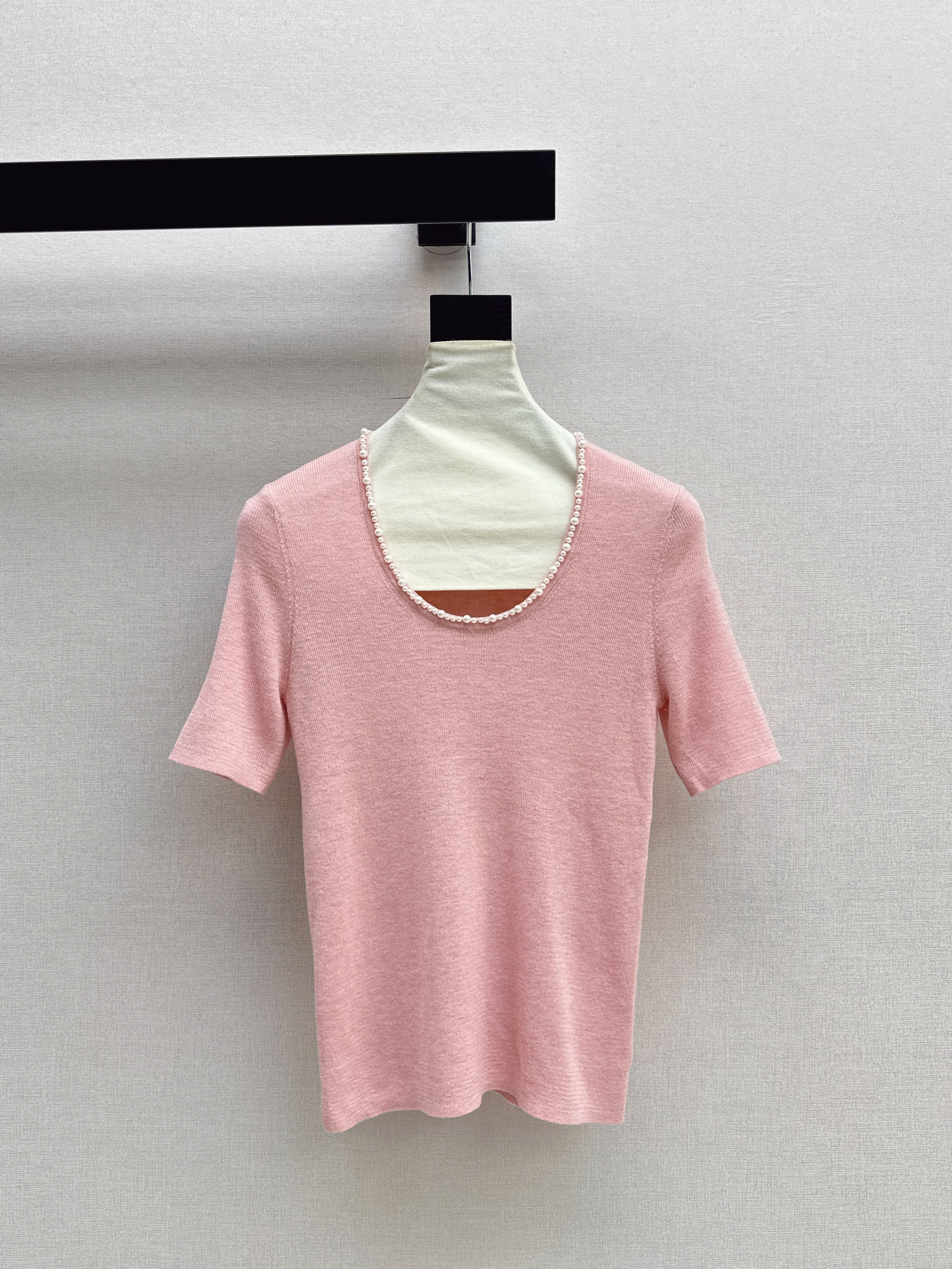 Pearl embellishments on a short-sleeved top